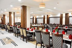 a large dining room with tables and chairs at Hotel Platinum Shravasti in Katra