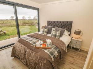 a bedroom with a bed with a tray of food on it at Saddlers in Stone