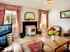 a living room with a fireplace and a table at Glen Gable in Fethard on Sea