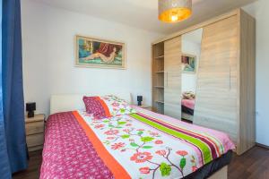 普拉的住宿－Sunny apartment ILI near Amfiteatar，一间卧室配有一张带彩色毯子的床
