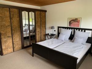 a bedroom with a large bed with white sheets at Vias Ferienwohnungen in Pünderich