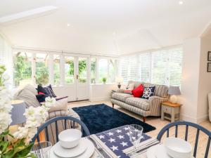 a living room with a couch and a table at Shepherds Cottage in Dulverton