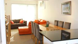a living room with a table and a couch at Angala 1 Lovely Woodridge 2-Bedroom Apartment in Thredbo