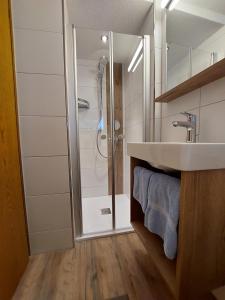 a bathroom with a shower and a sink at Gästehaus Rita in Sankt Anton am Arlberg