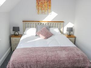 a bedroom with a large bed with two night stands at C64 Cahermore Holiday Village in Enniscrone