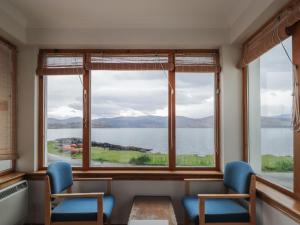 a room with a large window with a view of the water at Boatman's Cottage in Coillemore