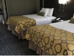 a hotel room with two beds in a room at Baymont by Wyndham Topeka in Topeka