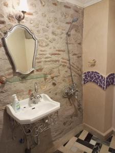 a bathroom with a sink and a shower at RIAD LA SANTA in Chefchaouene