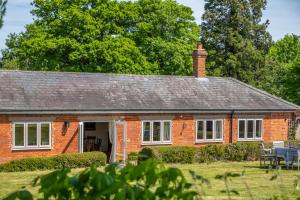 a red brick house with white windows at Charming cottage in beautiful countryside with a boating lake - The Calf Pens in Ipswich