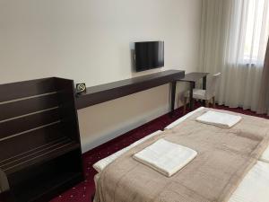 Ένα ή περισσότερα κρεβάτια σε δωμάτιο στο Anga Yerevan Hotel
