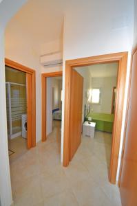 a room with two open doors and a bathroom at VillettaPuce in Corsano