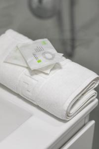 a stack of towels sitting on top of a counter at Imedio Azure Apartment Aviatiei in Bucharest