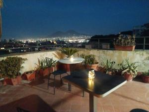 a patio with a table and chairs on a balcony at Casa vacanze Maison Zio Bruno A' Scalinatella in Naples