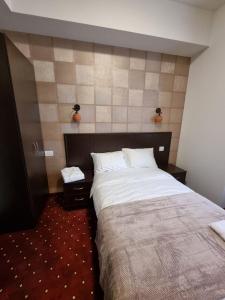 Ένα ή περισσότερα κρεβάτια σε δωμάτιο στο Anga Yerevan Hotel