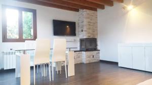 a dining room with a glass table and white chairs at Casa Rural Tejedor in Morillo de Monclús