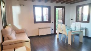 a living room with a glass table and a couch at Casa Rural Tejedor in Morillo de Monclús