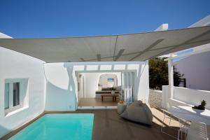 a villa with a swimming pool and a house at Olia Villa in Imerovigli