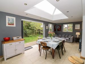 a kitchen and dining room with a table and chairs at Rosemead in Moreton in Marsh