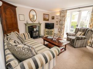 a living room with two couches and a fireplace at Rosemead in Moreton in Marsh