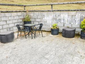a table and chairs with pots of plants at Sarah Magees in Enniskillen