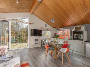 a kitchen and dining room with a table and chairs at Oaks One in Morpeth