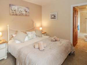 a bedroom with a bed with two towels on it at Bryn Elsi in Betws-y-coed