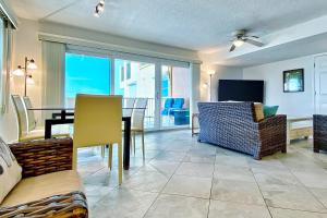 a living room with a table and a dining room at Holiday Villas III 703 in Clearwater Beach