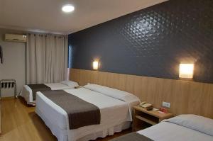 Postel nebo postele na pokoji v ubytování Hotel Rafain Centro