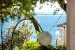 a view of a body of water from a window at Family Holiday house - 50 m to the beach! in Kožino