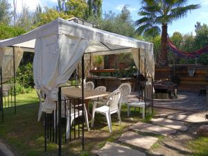 a tent with chairs and a table in a yard at Lodi House in Godoy Cruz