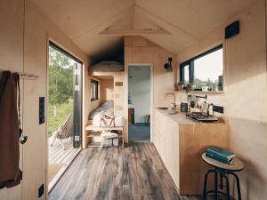 a tiny house with a kitchen and a living room at Camp Saltstraumen-Elvegård in Bodø