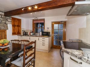 a kitchen with a table and a counter top at 2 The Square in Skipton