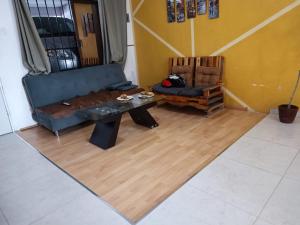 a living room with a couch and a table at El Costeñito Hostal in Veracruz