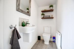 a bathroom with a sink and a toilet at Silver Stag Properties, 3 bedroom luxury house in Coalville +16 photos