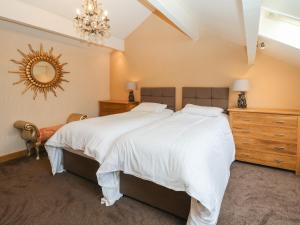 A bed or beds in a room at Rough Bank Barn