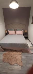 une chambre avec un grand lit avec une couverture sur le sol dans l'établissement Gîte le jardin d eau, à Lamothe-Montravel