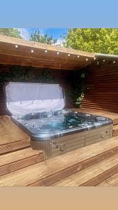 a jacuzzi tub in a wooden enclosure at Woolston lodge in Oswestry