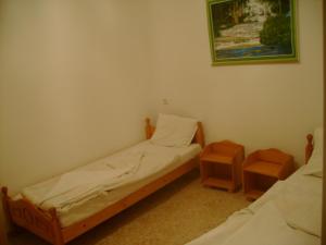 a bedroom with two beds and a picture on the wall at Къща за гости Костови in Byala