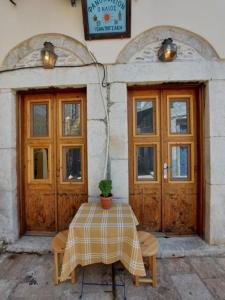 a table in front of a building with two doors at Ήλιος Πατσακης in Symi