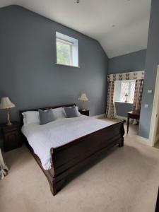 a bedroom with a large bed and a window at The Coach House in Dublin