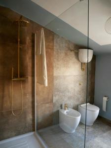 a bathroom with a shower with a toilet and a sink at La Bella di Lajatico in Lajatico