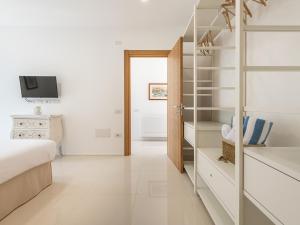 a bedroom with a bed and a walk in closet at Luxury Poetto Apartments in Cagliari