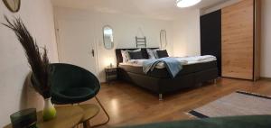 a bedroom with a bed and a chair in a room at Haus Charlotte in Bruttig-Fankel
