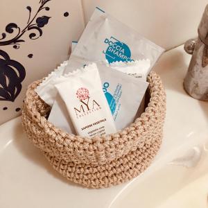 a basket filled with products sitting on a table at Holiday House in Alghero