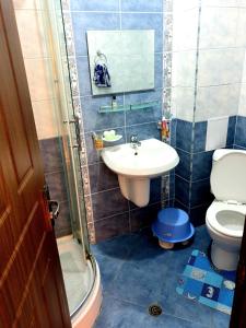 a bathroom with a sink and a toilet at Sunny House Family in Nesebar