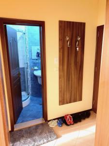 a bathroom with a shower and a glass door at Sunny House Family in Nesebar