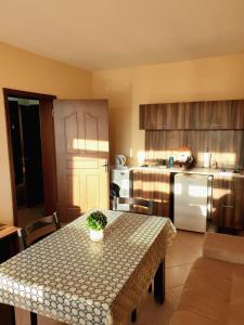 a kitchen with a table and a kitchen with a table and a kitchen at Sunny House Family in Nesebar