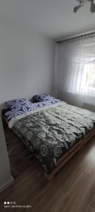 a bed sitting in a bedroom with a window at Apartament „Nad Jeziorkiem“ in Kętrzyn