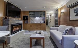 a living room with a couch and a fireplace at The Carlin Boutique Hotel in Queenstown