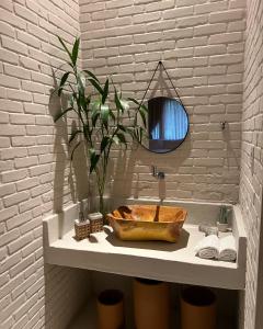 a bathroom with a wooden sink and a mirror at KANAHA BEACH VILLA in Icaraí +107 photos